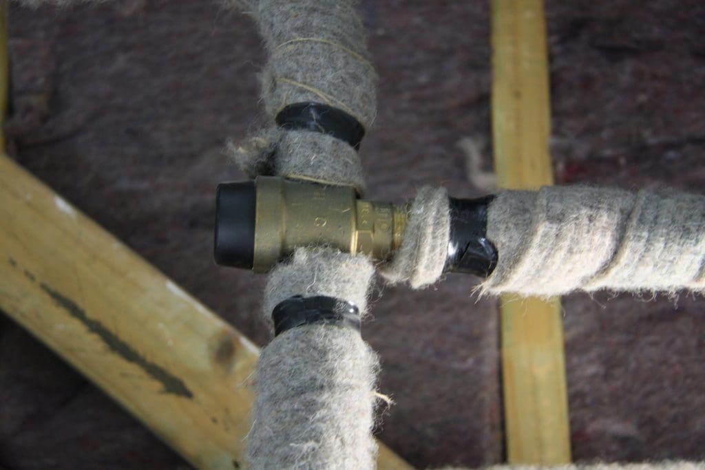 Pipe lagging wool insulation on plumbing pipes T joint